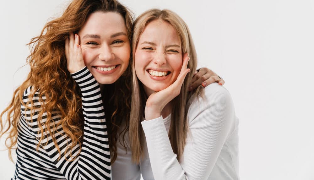 Young,Two,Women,Laughing,While,Making,Fun,Together,On,Camera