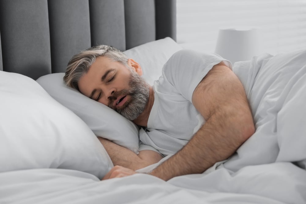 Man,Snoring,While,Sleeping,In,Bed,At,Home