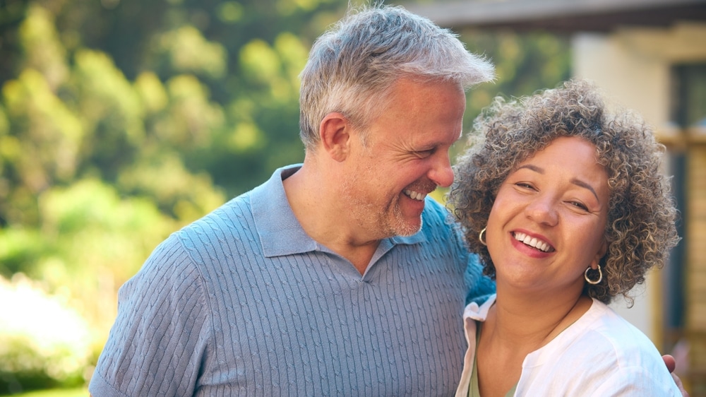 Portrait,Of,Laughing,And,Smiling,Mature,Multi-racial,Couple,Standing,Outdoors