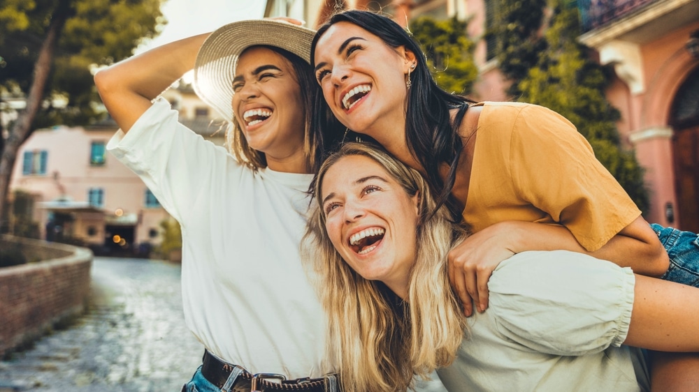 Three,Multiethnic,Girls,Having,Fun,Walking,In,City,Street,