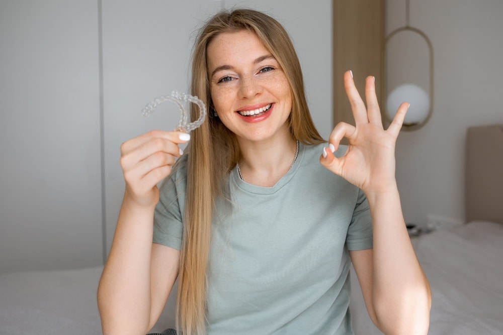A,Cheerful,Woman,In,A,Casual,Shirt,Holds,A,Transparent